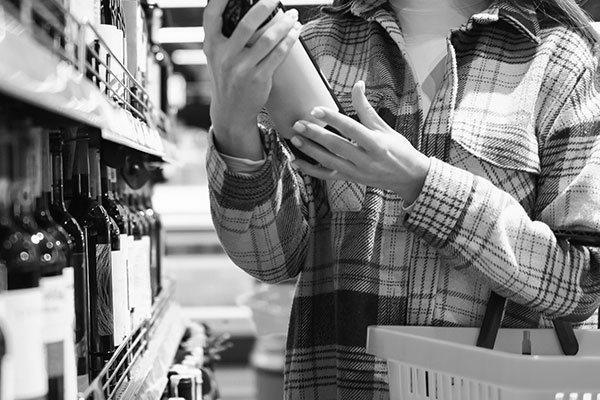 woman shopping in fully stocked wine section